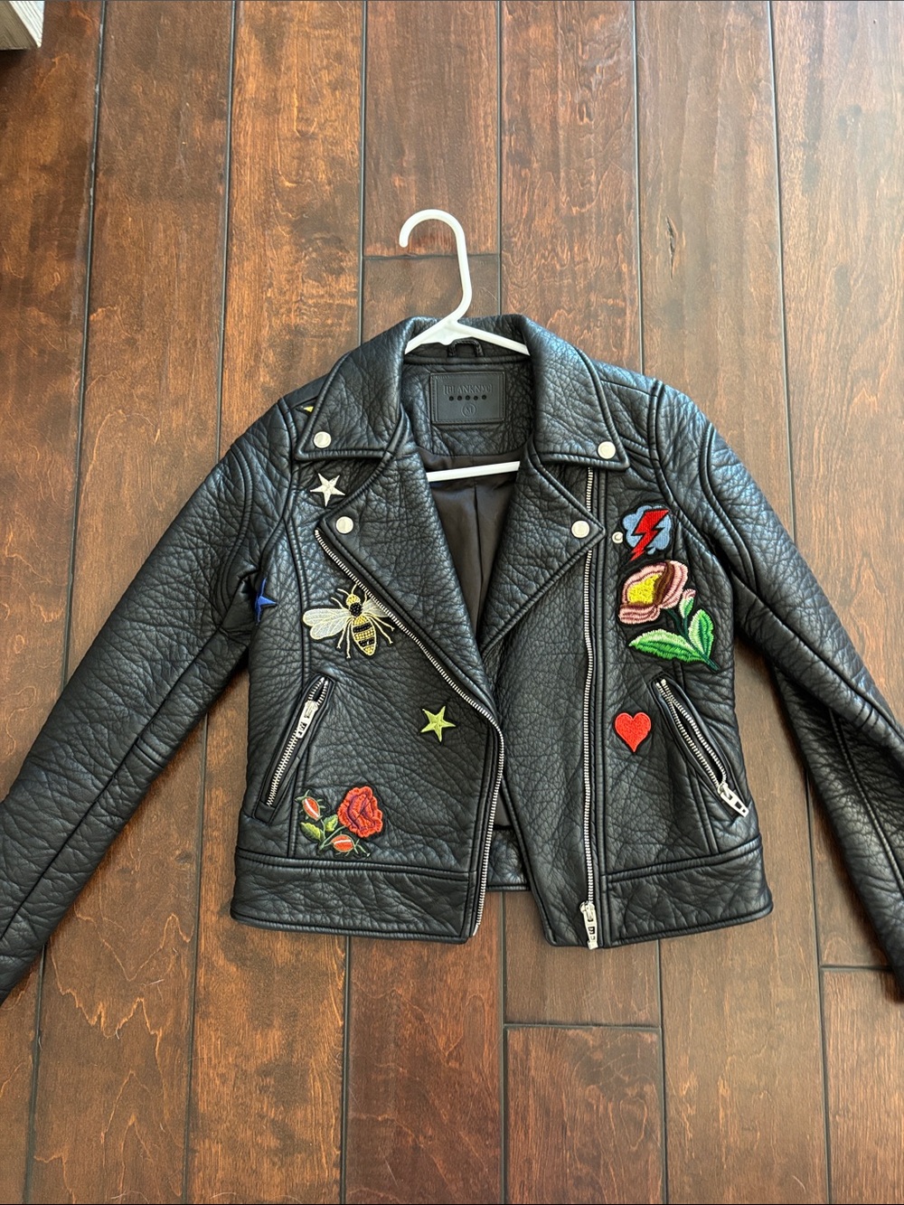 Blank NYC Black faux Leather Moto Jacket with Colorful Embroidered Patches